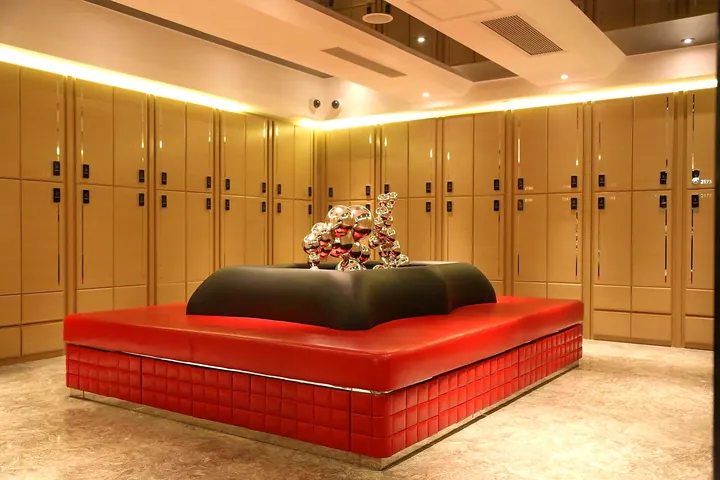 Gold locker room with red bench