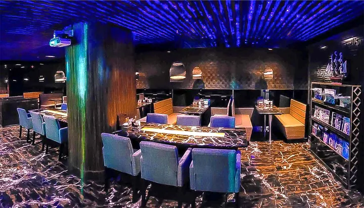 Blue-lit dining room