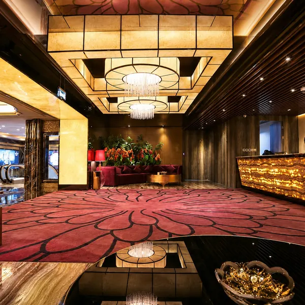 Gold-toned reception lobby with carpeted walkway