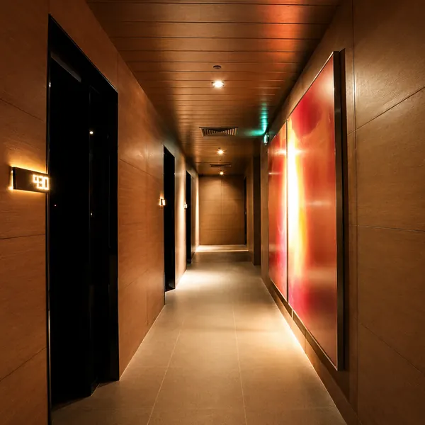 Warm-lit private room corridor