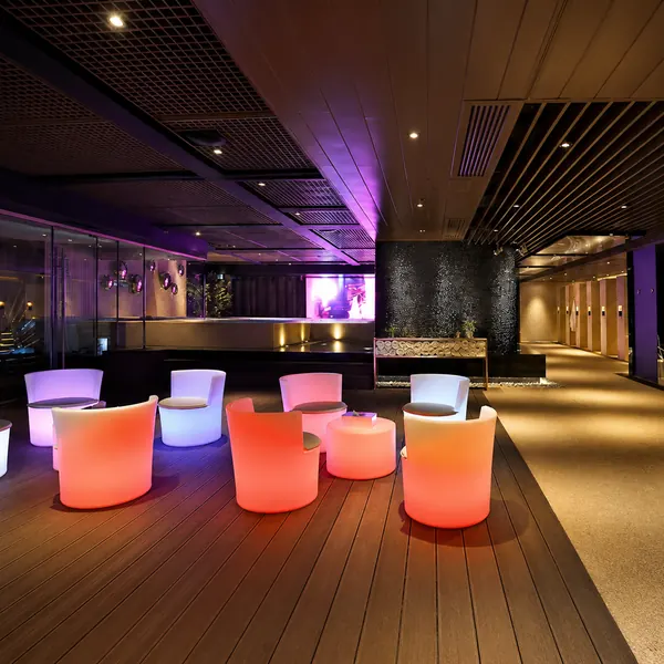 Purple-lit terrace-style lounge